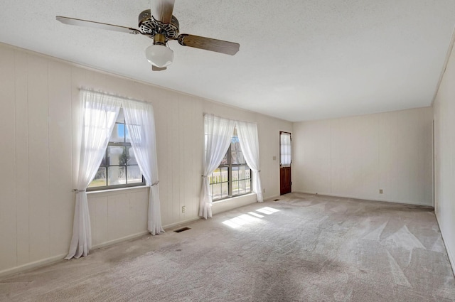 unfurnished room featuring carpet floors and ceiling fan