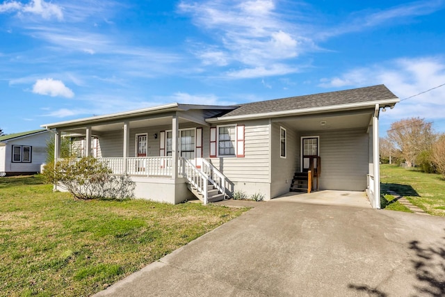 view of front of home featuring covered porch, a front lawn, driveway, and an attached carport