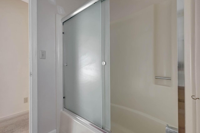 bathroom featuring combined bath / shower with glass door