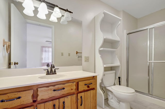 full bath with tile patterned flooring, a shower stall, vanity, and toilet