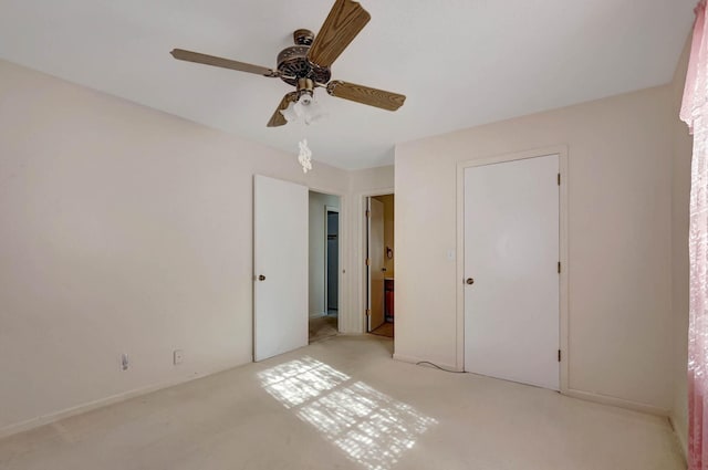unfurnished bedroom with light carpet and a ceiling fan
