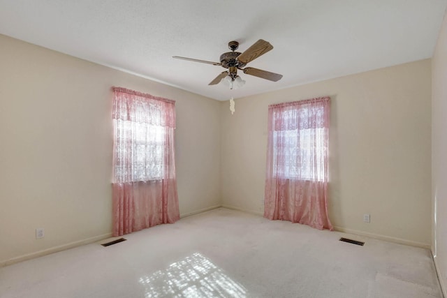 unfurnished room featuring a ceiling fan, carpet flooring, and baseboards