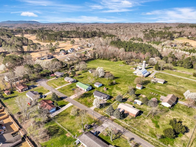 aerial view of property and surrounding area with nearby suburban area
