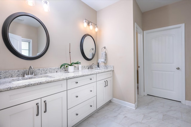 105 Bowwater Pl, Gallatin, TN 37066 - bathroom featuring marble look tile flooring, baseboards, and double vanity