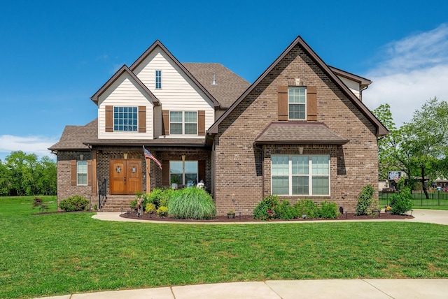 105 Bowwater Pl, Gallatin, TN 37066 - view of front of home with brick siding, a front lawn, and a shingled roof