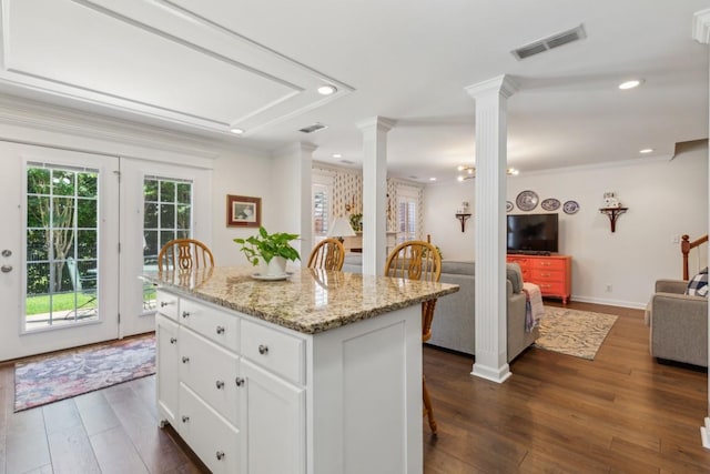 3348 Berryside Dr, Murfreesboro, TN 37128 - kitchen featuring decorative columns, open floor plan, dark wood-style flooring, ornamental molding, and white cabinets