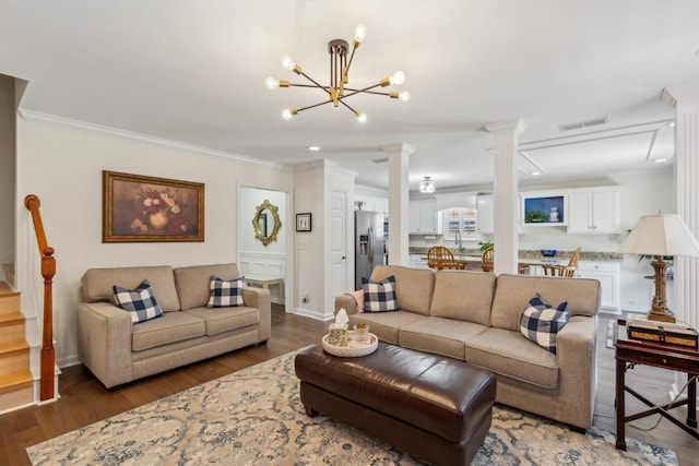 3348 Berryside Dr, Murfreesboro, TN 37128 - living room with decorative columns, crown molding, wood finished floors, a chandelier, and stairway