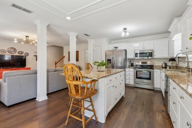 3348 Berryside Dr, Murfreesboro, TN 37128 - kitchen featuring stainless steel appliances, a sink, open floor plan, decorative columns, and crown molding