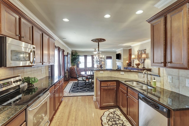 3157 Locust Holw, Nolensville, TN 37135 - kitchen with stainless steel appliances, open floor plan, a sink, light wood-style flooring, and ornamental molding