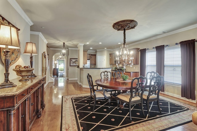 3157 Locust Holw, Nolensville, TN 37135 - dining area featuring a chandelier, arched walkways, crown molding, light wood-style floors, and plenty of natural light