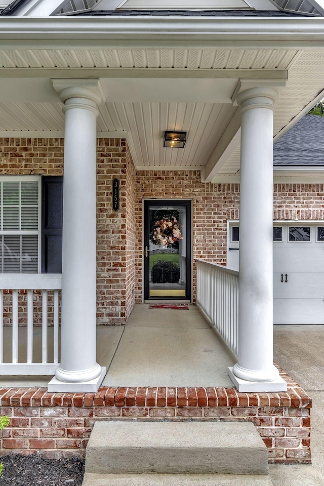 3157 Locust Holw, Nolensville, TN 37135 - view of exterior entry featuring brick siding, a porch, and a shingled roof