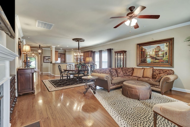 3157 Locust Holw, Nolensville, TN 37135 - living room with a chandelier, light wood-style flooring, ornamental molding, a ceiling fan, and a fireplace