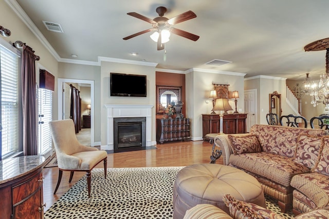 3157 Locust Holw, Nolensville, TN 37135 - living room with a chandelier, light wood-style flooring, a fireplace with flush hearth, ceiling fan, and crown molding