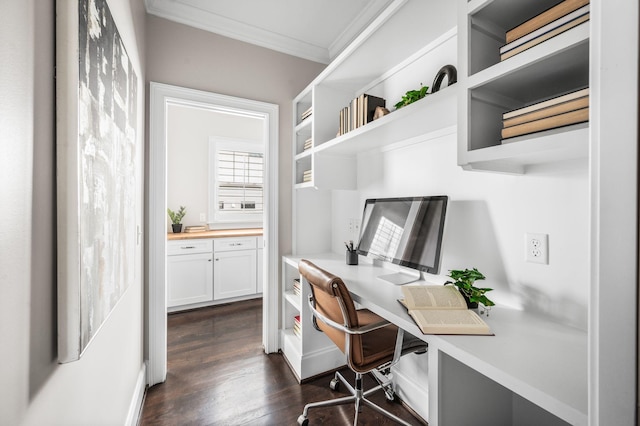 home office featuring ornamental molding, built in study area, and dark wood-type flooring