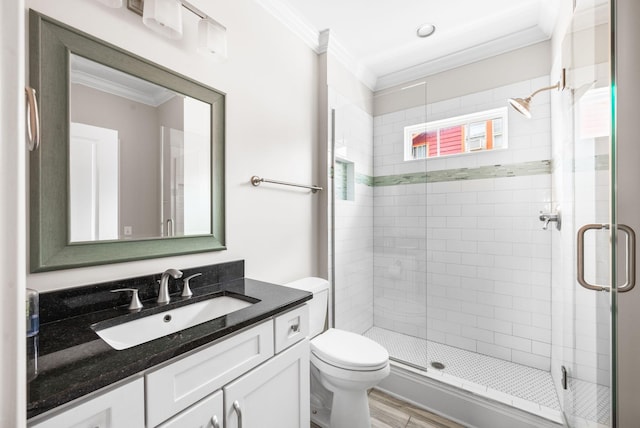 full bathroom with crown molding, toilet, a stall shower, vanity, and wood finished floors