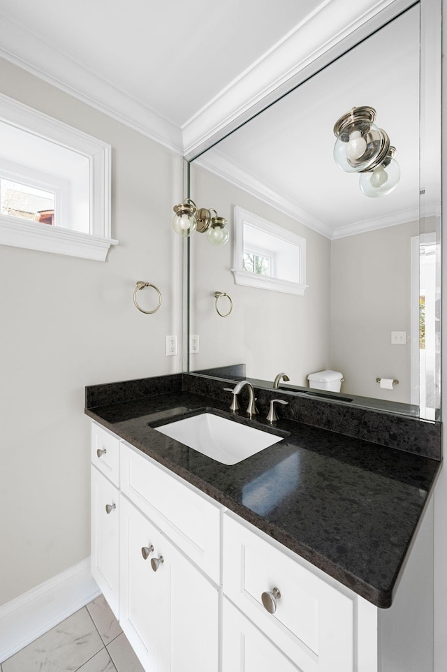 bathroom featuring crown molding, vanity, marble look tile flooring, and baseboards