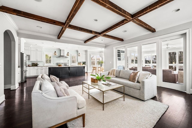 living room with coffered ceiling, beamed ceiling, dark wood-type flooring, baseboards, and arched walkways
