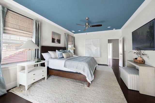 bedroom with wood finished floors, crown molding, baseboards, ceiling fan, and recessed lighting