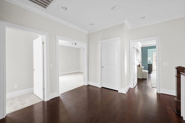 unfurnished living room with dark wood-style flooring, ornamental molding, and baseboards