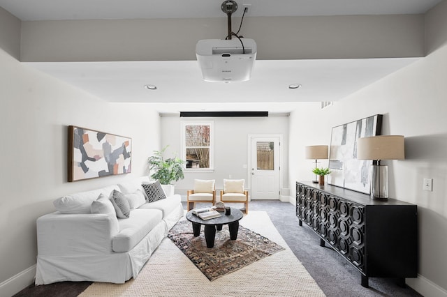 carpeted living room featuring baseboards and recessed lighting