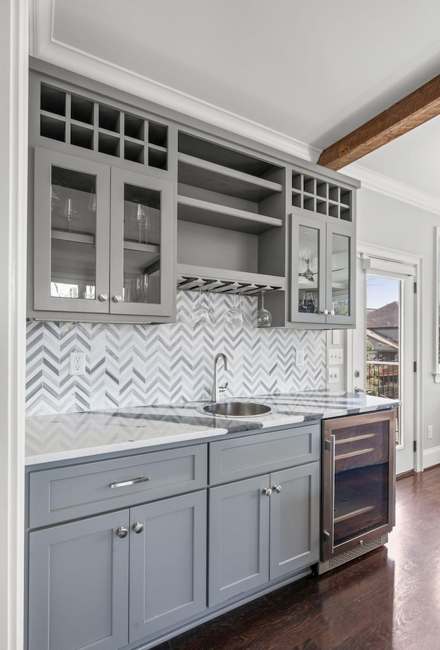 bar area with beverage cooler, a sink, crown molding, tasteful backsplash, and dark wood-style floors
