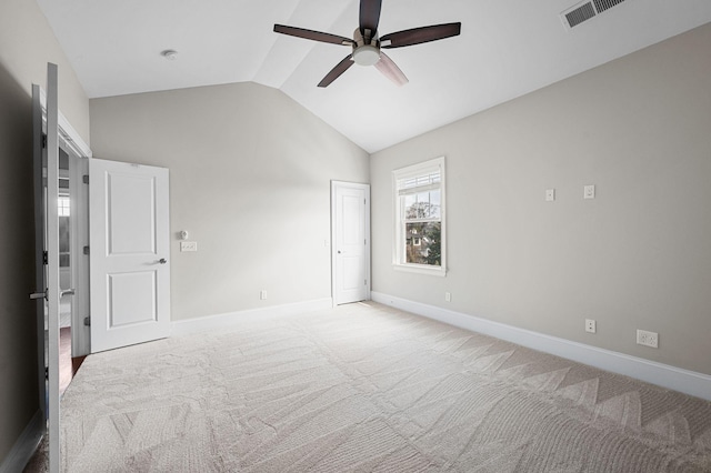 unfurnished bedroom featuring baseboards, lofted ceiling, carpet floors, and ceiling fan