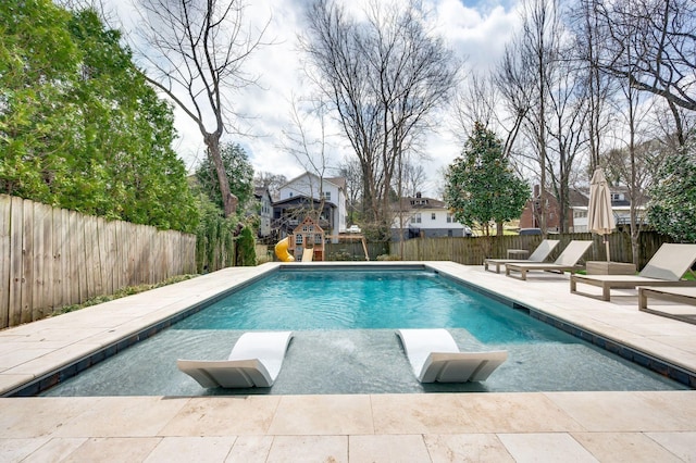 view of swimming pool with a fenced backyard, a patio area, and a playground