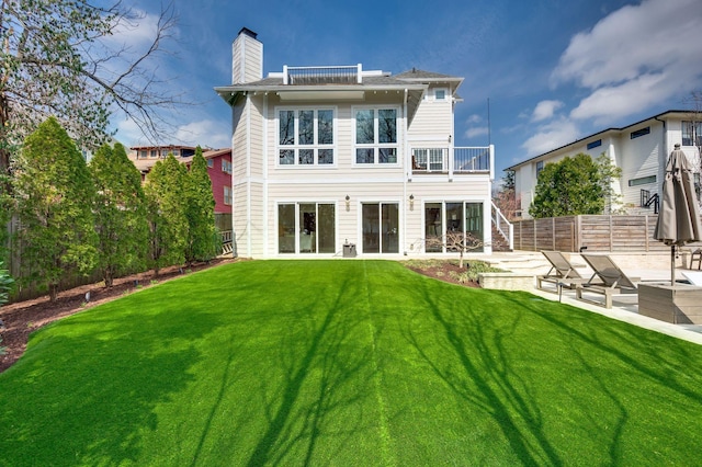 back of house featuring stairway, a chimney, a patio, and a balcony
