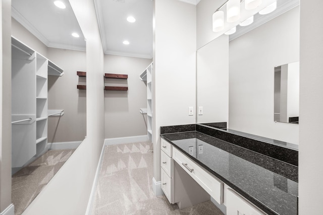 bathroom featuring ornamental molding, recessed lighting, baseboards, and vanity