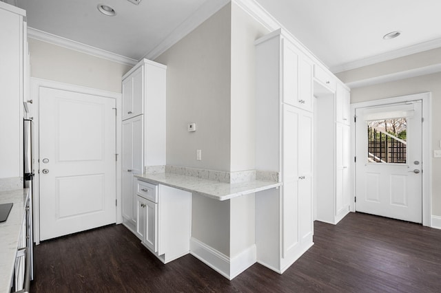 kitchen featuring ornamental molding, dark wood-style flooring, white cabinets, light stone counters, and a peninsula