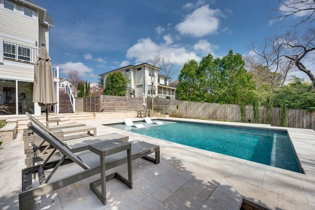view of pool with stairs, a patio area, and a fenced backyard
