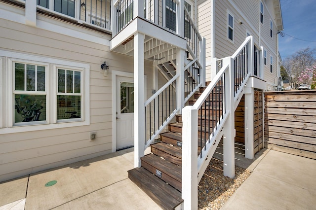 view of exterior entry featuring a balcony and a patio area