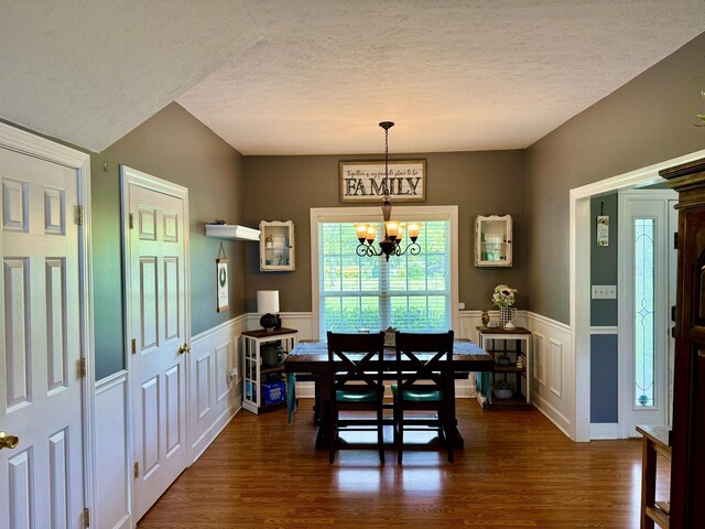 435 Long St W, Mc Ewen, TN 37101 - dining room with a textured ceiling, a chandelier, dark wood-style flooring, and a wainscoted wall