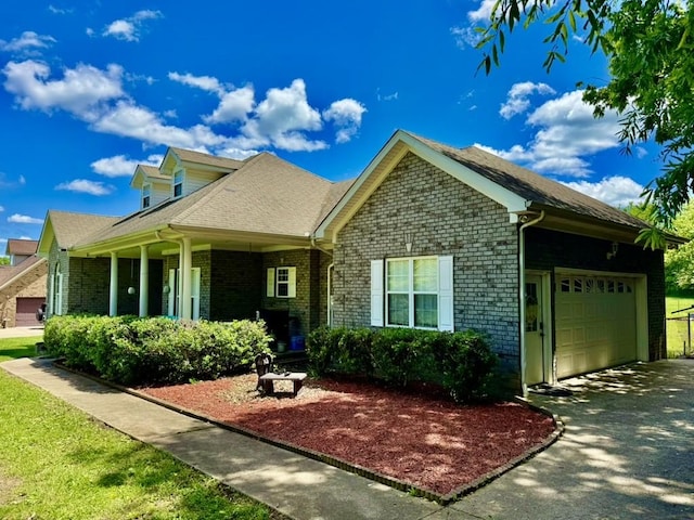 435 Long St W, Mc Ewen, TN 37101 - view of front of home featuring a garage, asphalt driveway, and brick siding