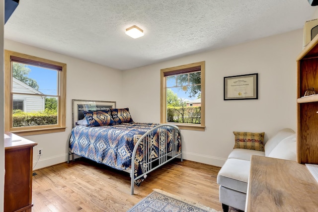 517 Drake Ave, Nashville, TN 37211 - bedroom featuring baseboards, wood finished floors, and a textured ceiling