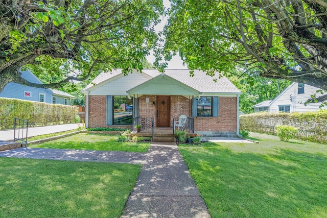 517 Drake Ave, Nashville, TN 37211 - bungalow featuring brick siding, covered porch, and roof with shingles