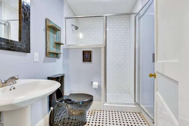 517 Drake Ave, Nashville, TN 37211 - bathroom with a shower stall, toilet, a sink, and tile patterned flooring