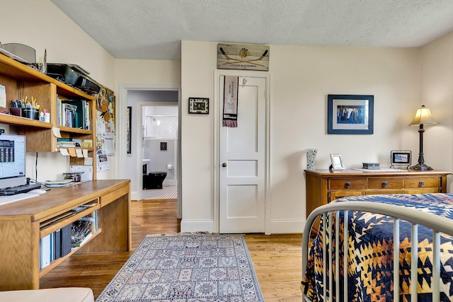 517 Drake Ave, Nashville, TN 37211 - bedroom featuring wood finished floors, an office area, a textured ceiling, and baseboards