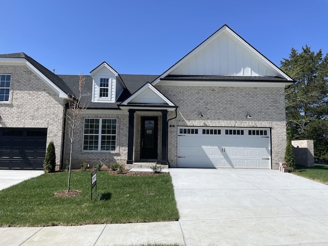 125 Lightberry Ln, Hendersonville, TN 37075 - view of front of house with brick siding, driveway, board and batten siding, a front lawn, and a garage