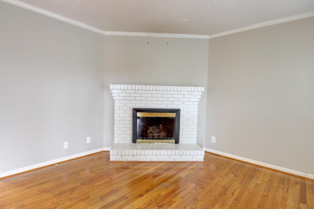 2172 Memorial Dr Unit C3, Clarksville, TN 37043 - unfurnished living room with wood finished floors, crown molding, baseboards, and a brick fireplace
