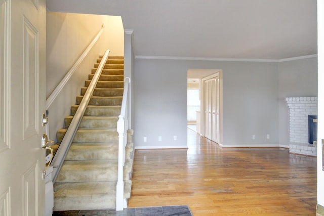 2172 Memorial Dr Unit C3, Clarksville, TN 37043 - stairway featuring crown molding, wood finished floors, baseboards, and a brick fireplace
