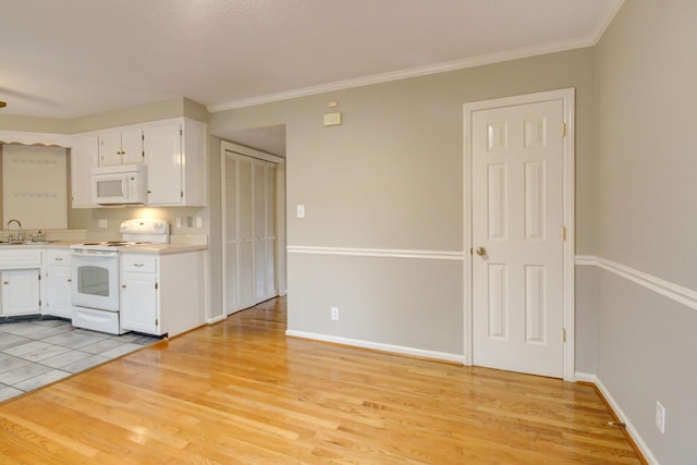 2172 Memorial Dr Unit C3, Clarksville, TN 37043 - kitchen with white appliances, white cabinetry, light wood-style floors, light countertops, and crown molding