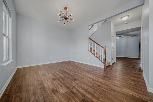 474 Parmley Dr, Nashville, TN 37207 - unfurnished room featuring stairway, dark wood-style flooring, a chandelier, and plenty of natural light