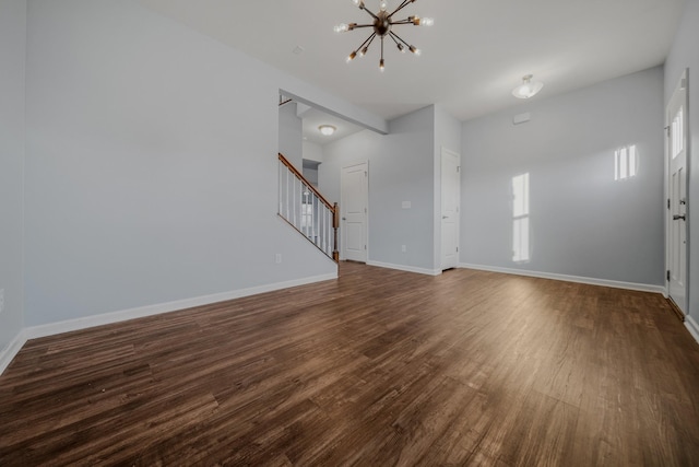 474 Parmley Dr, Nashville, TN 37207 - unfurnished living room with a chandelier, stairs, dark wood-style floors, and baseboards