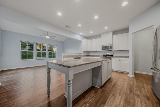 474 Parmley Dr, Nashville, TN 37207 - kitchen featuring stainless steel appliances, wood finished floors, light stone countertops, a ceiling fan, and white cabinets