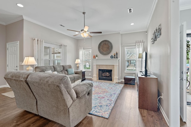 2139 Stonecenter Ln, Murfreesboro, TN 37128 - living area featuring ceiling fan, healthy amount of natural light, wood finished floors, a tile fireplace, and ornamental molding