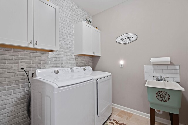 2139 Stonecenter Ln, Murfreesboro, TN 37128 - clothes washing area with washer and clothes dryer, cabinet space, and baseboards
