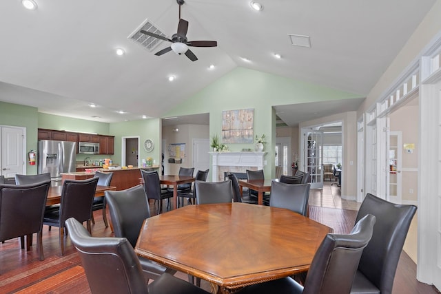 2139 Stonecenter Ln, Murfreesboro, TN 37128 - dining room with a ceiling fan, high vaulted ceiling, a tile fireplace, wood finished floors, and recessed lighting