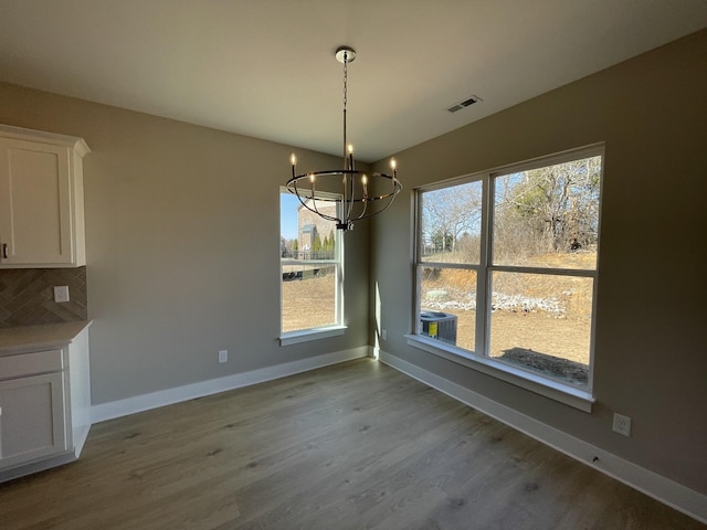 121 Lightberry Ln, Hendersonville, TN 37075 - unfurnished dining area featuring a chandelier, baseboards, wood finished floors, and healthy amount of natural light