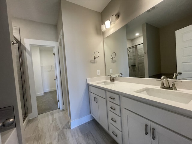 121 Lightberry Ln, Hendersonville, TN 37075 - full bathroom featuring a shower stall, double vanity, a walk in closet, and baseboards
